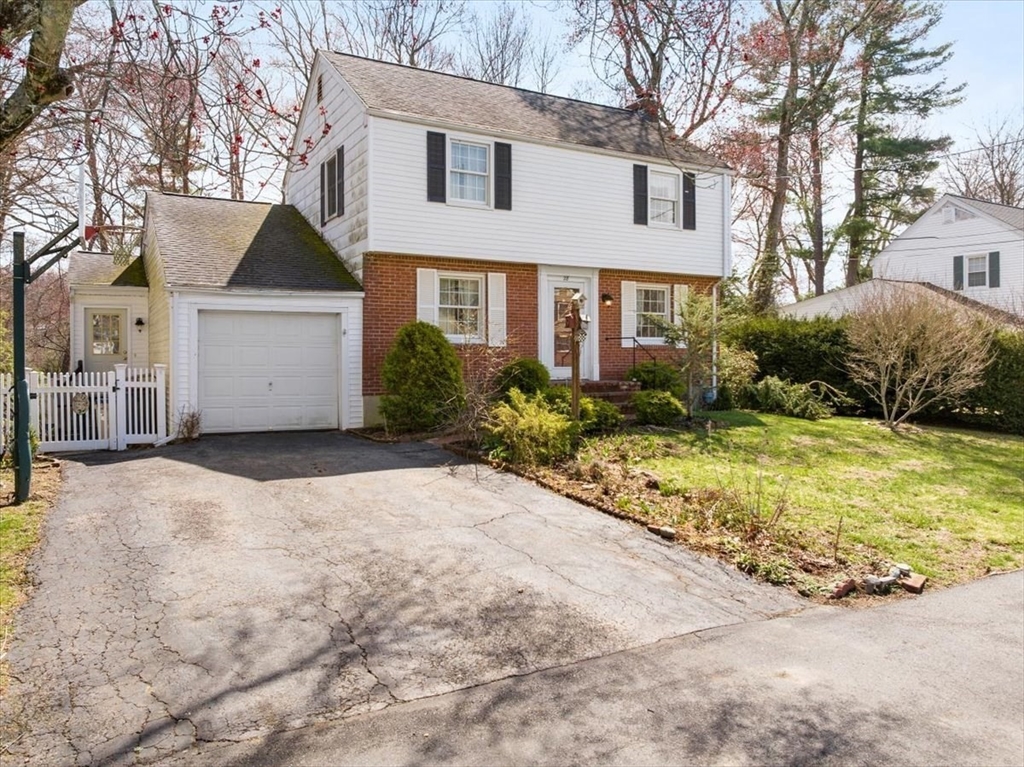 28 Barnesdale Road Natick, MA 01760 - Photo 2 of 33 a front view of a house with a yard and garage