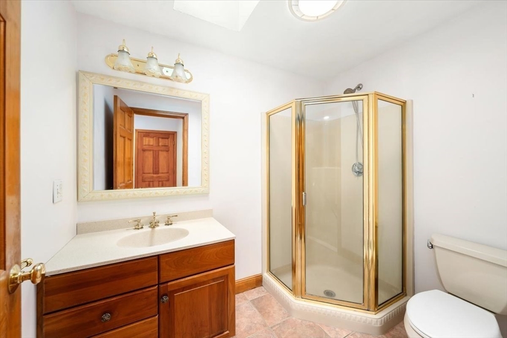 28 Barnesdale Road Natick, MA 01760 - Photo 29 of 33 a bathroom with a sink mirror vanity and toilet
