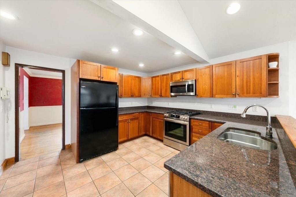 28 Barnesdale Road Natick, MA 01760 - Photo 8 of 33 a kitchen with stainless steel appliances granite countertop a refrigerator a sink a stove a microwave a counter top and oven