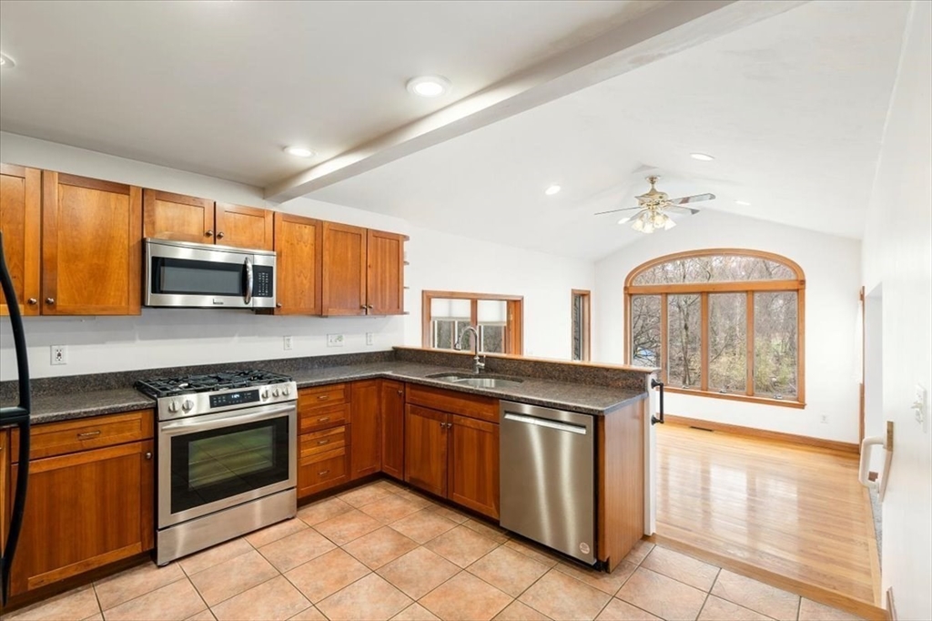 28 Barnesdale Road Natick, MA 01760 - Photo 10 of 33 a kitchen with stainless steel appliances granite countertop a stove top oven and sink