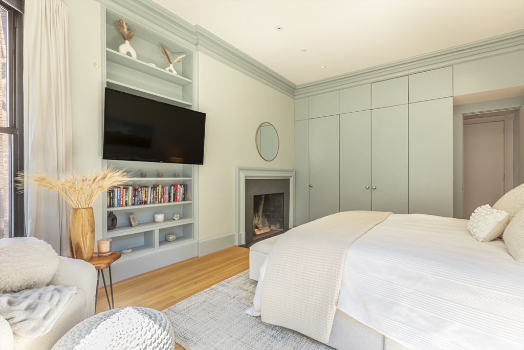 33 Bay State Road, Unit 3 Boston, MA 02215 - Photo 12 of 25 a spacious bedroom with a bed and a flat screen tv