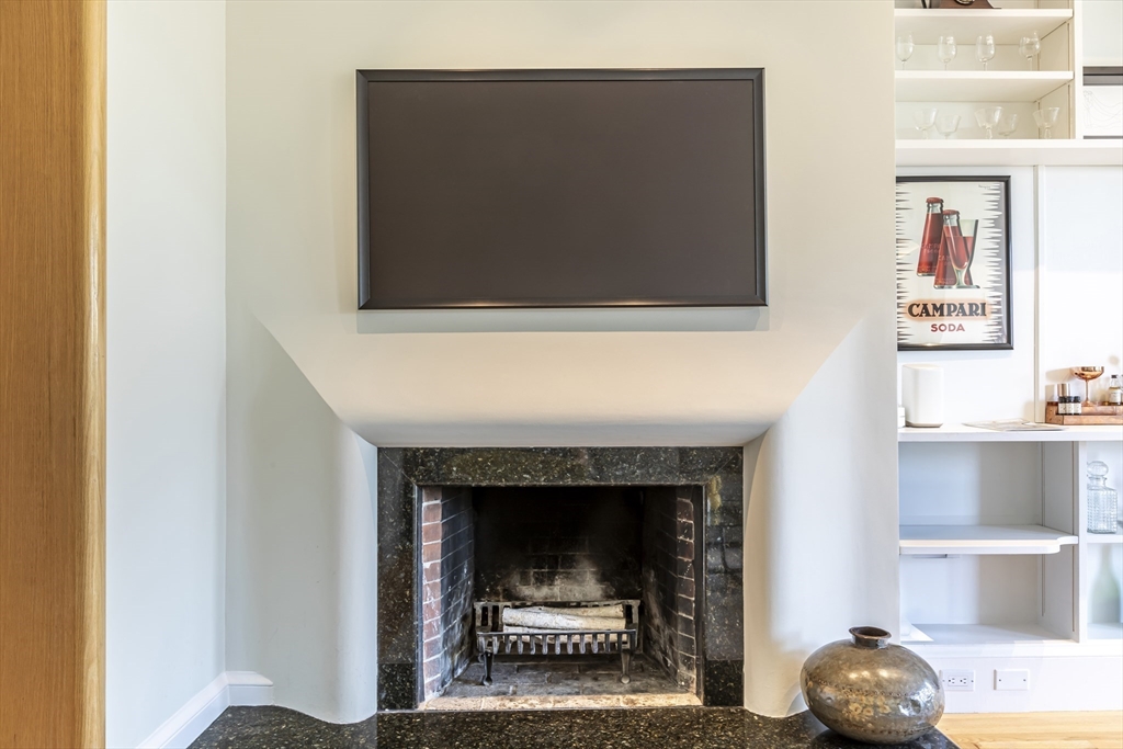 33 Bay State Road, Unit 3 Boston, MA 02215 - Photo 5 of 25 a living room with a fireplace