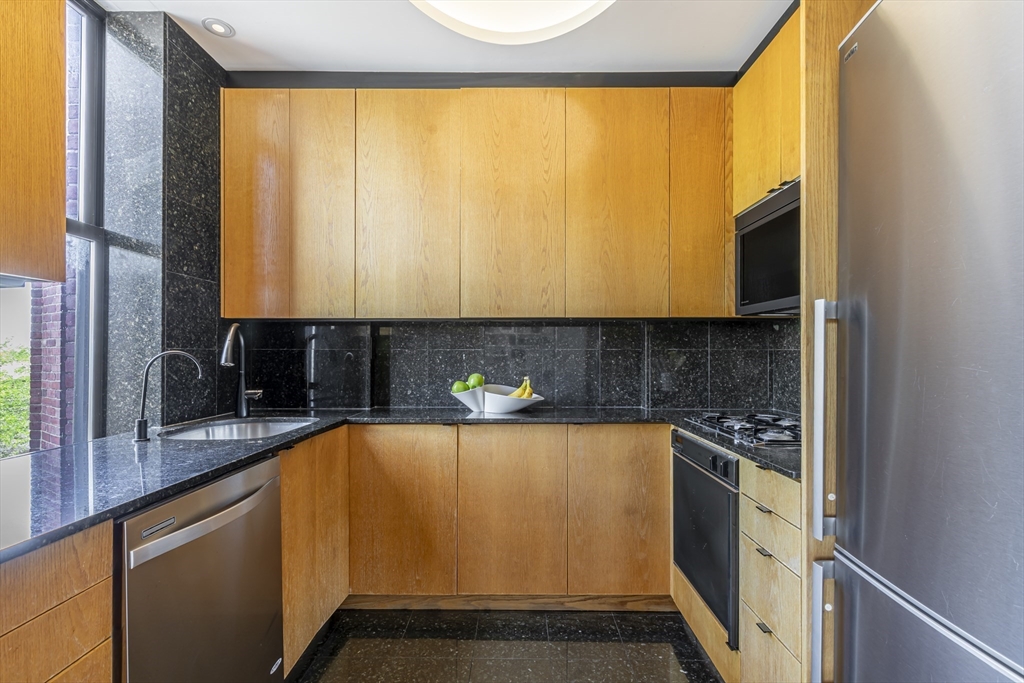 33 Bay State Road, Unit 3 Boston, MA 02215 - Photo 7 of 25 a view of a kitchen with a sink and cabinets