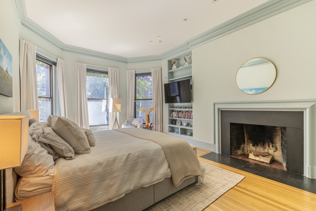 33 Bay State Road, Unit 3 Boston, MA 02215 - Photo 9 of 25 a bedroom with a bed and a fireplace