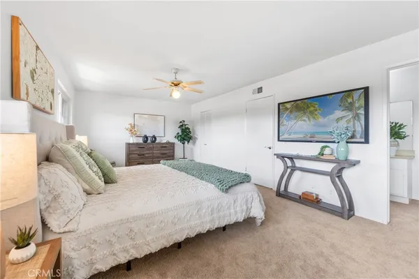 a bedroom with a bed and a painting on the wall