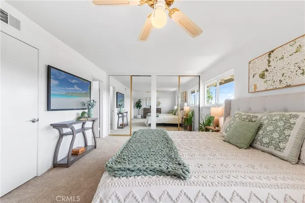 a living room with furniture a couch and large window