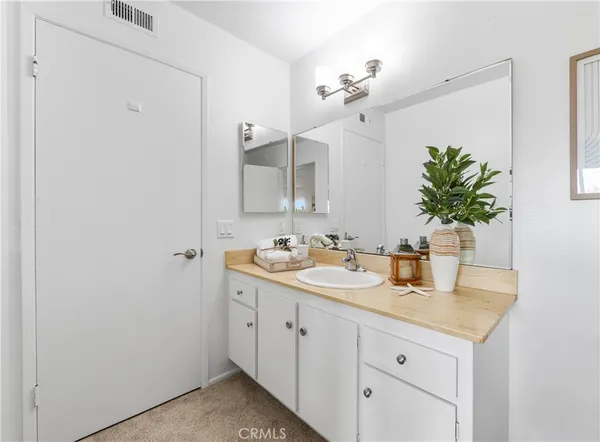 a bathroom with a double vanity sink and a mirror