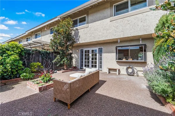 a view of a house with sitting area and garden