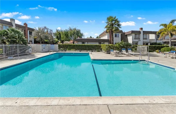 a view of a swimming pool with outdoor seating