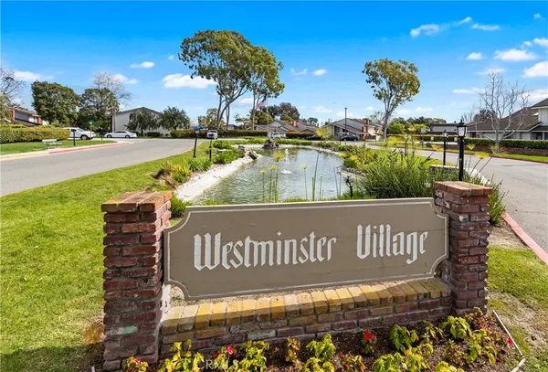 a view of swimming pool with outdoor seating and trees in the background