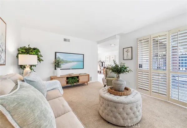 a living room with furniture and a potted plant