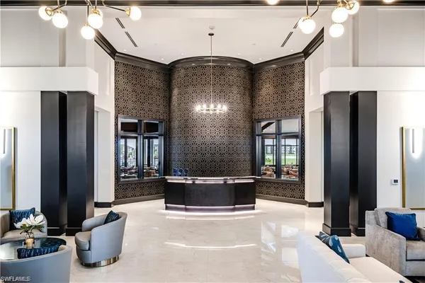 a living room with furniture a large mirror and a chandelier