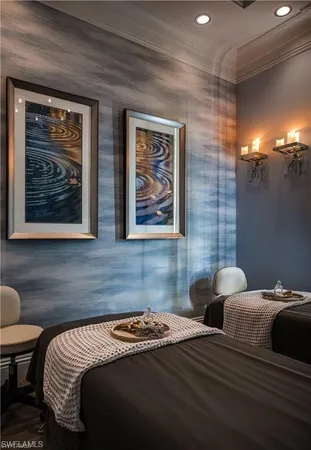 a bedroom with bed and painting on the wall