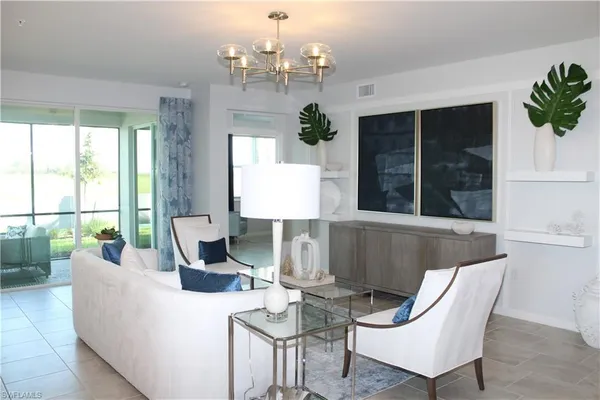 a living room with furniture and a large window