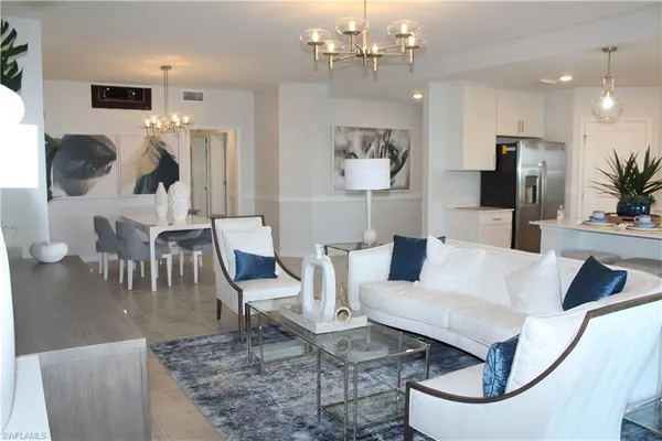 a living room with furniture and a chandelier
