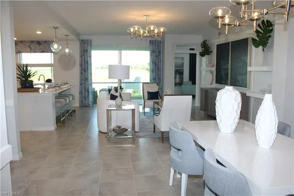 a dining room with furniture and a chandelier