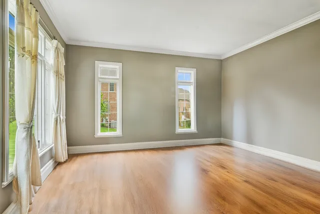 a view of empty room with fireplace and large windows