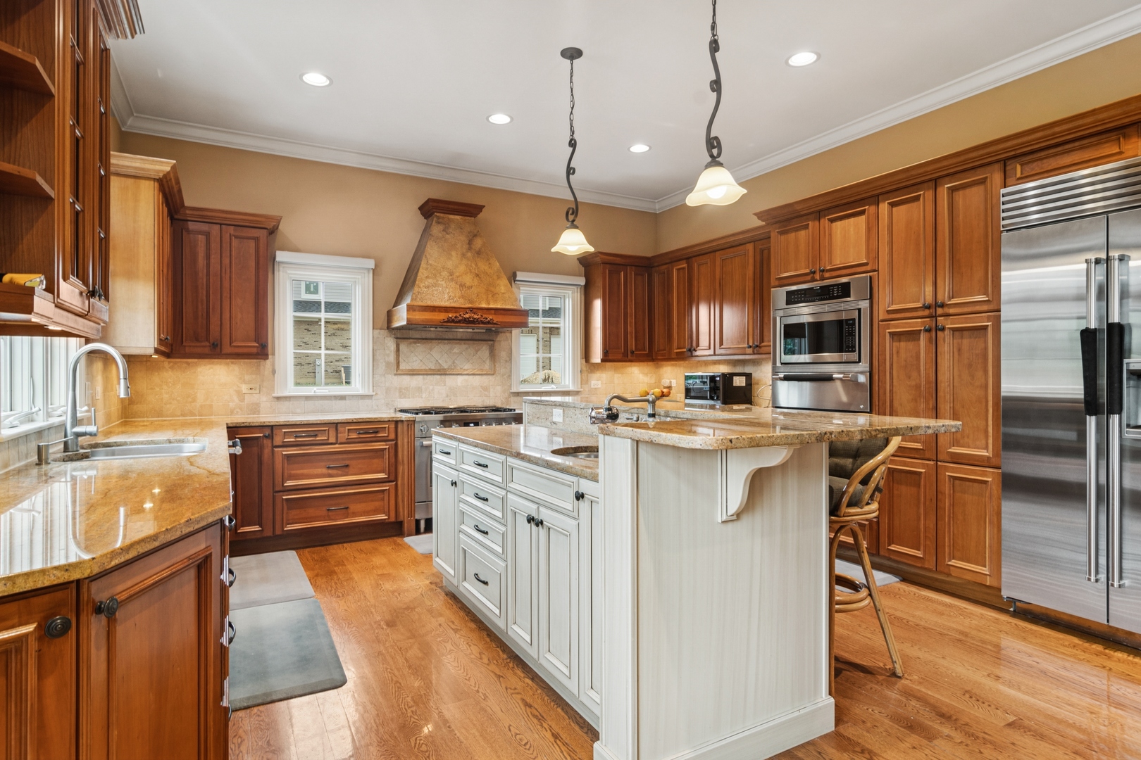 22292 North Prairie Lane Kildeer, IL 60047 - Photo 15 of 85 a kitchen with stainless steel appliances granite countertop a stove top oven a refrigerator a sink and dishwasher with wooden floor