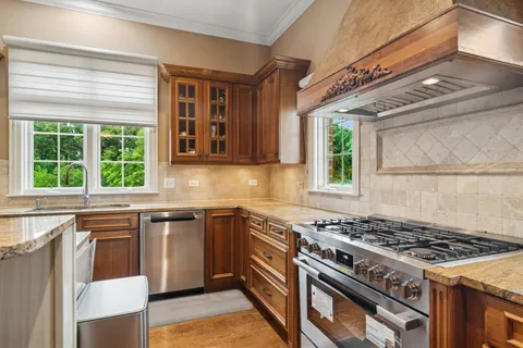 an empty room with windows and cabinet
