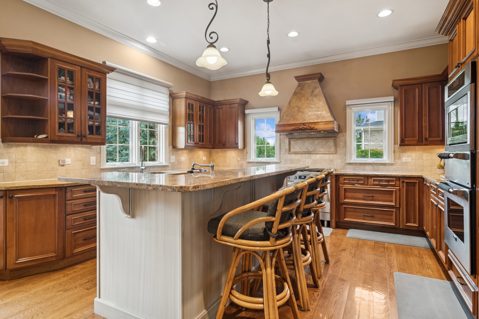22292 North Prairie Lane Kildeer, IL 60047 - Photo 19 of 85 a kitchen with stainless steel appliances kitchen island granite countertop a stove a sink and a wooden cabinets