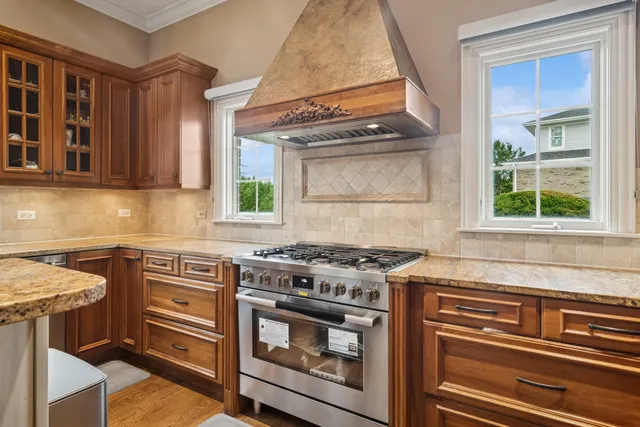 a bathroom with a granite countertop sink mirror vanity and toilet
