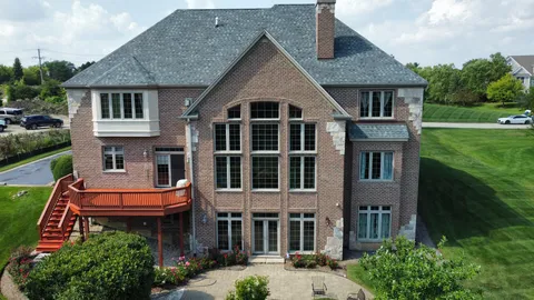 a front view of a house with a garden and plants