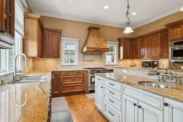 a bathroom with a granite countertop sink and a mirror with toilet