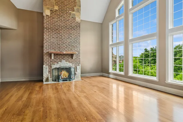 an empty room with a fireplace and window
