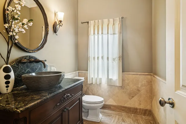a bathroom with a sink vanity and a mirror