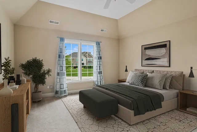 a aerial view of a house with a yard plants and large tree