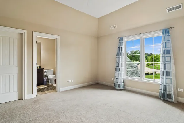 a aerial view of a house with yard and green space