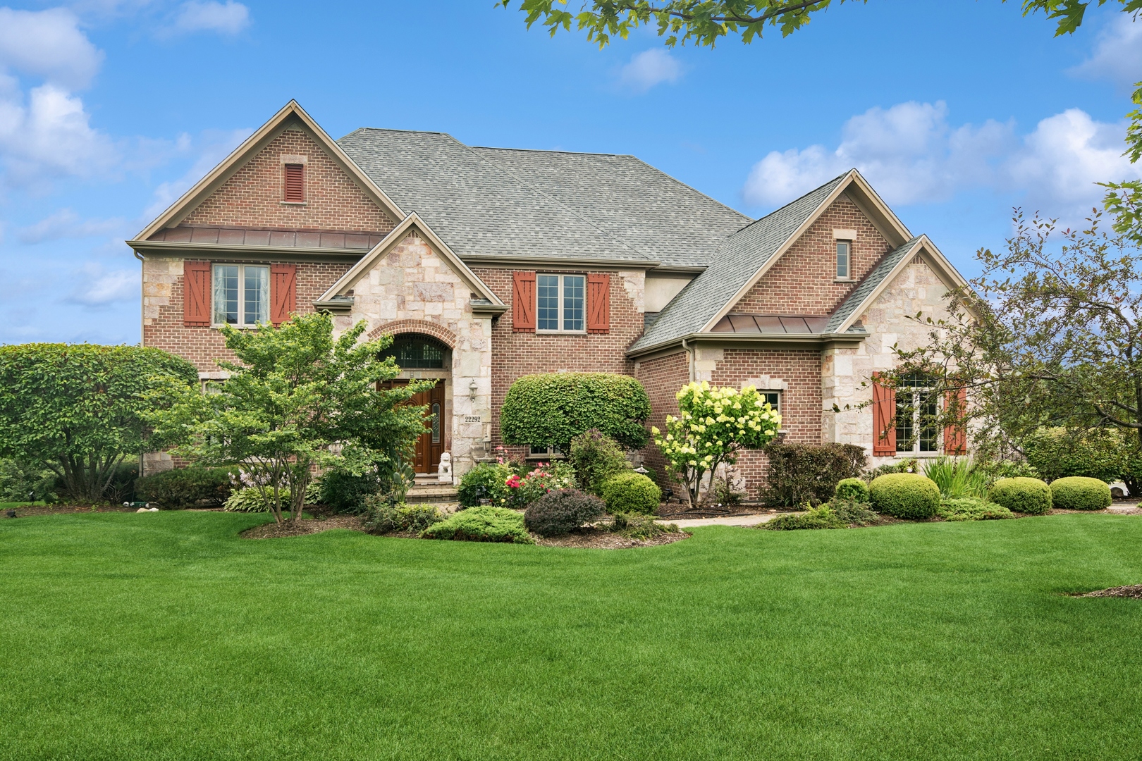 22292 North Prairie Lane Kildeer, IL 60047 - Photo 7 of 85 a front view of a house with a garden and plants