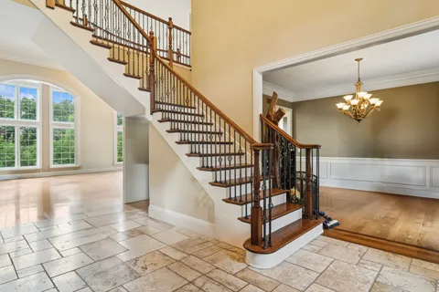 a kitchen with stainless steel appliances granite countertop a stove top oven a refrigerator a sink and dishwasher with wooden floor