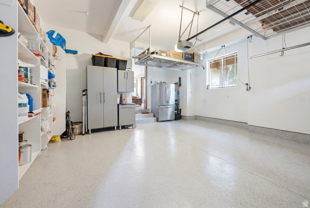 3148 Lower Saddleback Road Park City, UT 84098 - Photo 56 of 67 Garage with light-colored epoxy flooring, integrated shelving, built-in cabinetry, and overhead storage racks