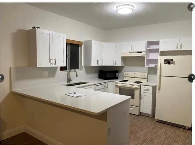 a kitchen with a refrigerator stove and sink