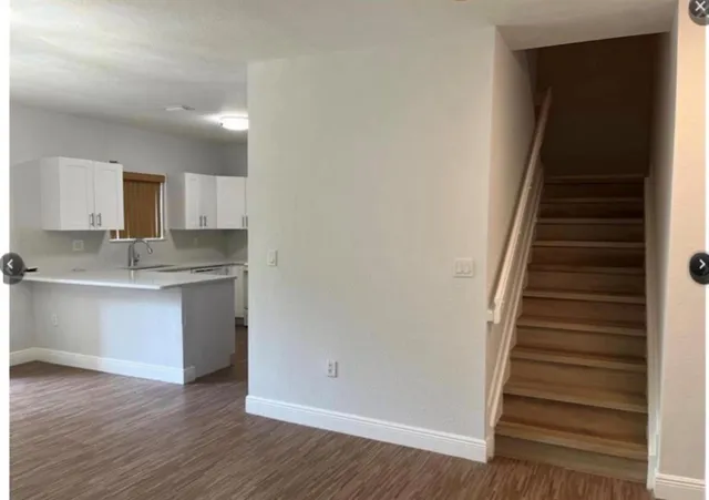 a view of kitchen with sink and wooden floor