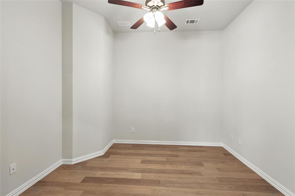 921 Alberta Spruce Road Justin, TX 76247 - Photo 17 of 24 Unfurnished room with wood finished floors and a ceiling fan