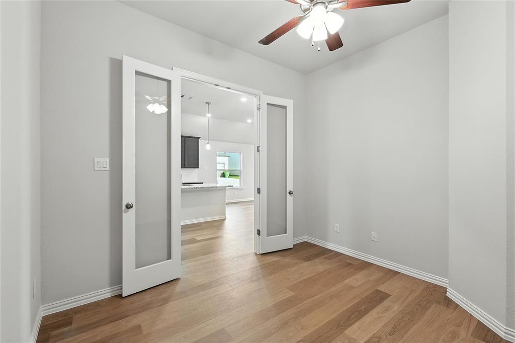 921 Alberta Spruce Road Justin, TX 76247 - Photo 18 of 24 Unfurnished room with ceiling fan, light wood-type flooring, and french doors