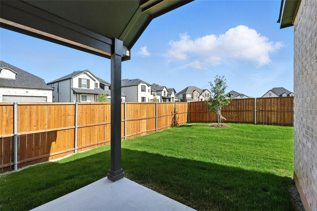 921 Alberta Spruce Road Justin, TX 76247 - Photo 23 of 24 Fenced backyard featuring a residential view and a patio