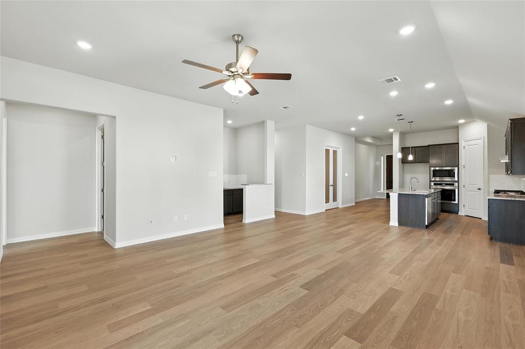 921 Alberta Spruce Road Justin, TX 76247 - Photo 9 of 24 Unfurnished living room with ceiling fan, light wood finished floors, and recessed lighting