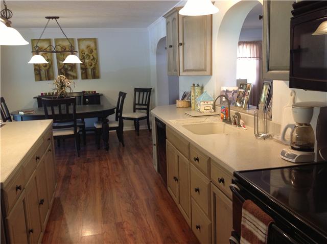420 Ridgewood Drive Manchester, TN 37355 - Photo 4 of 15 Looking from the other side of the kitchen. The kitchen also has an arched pass through that looks into the den. Love those country French cabinets. Very stylish and sleek.