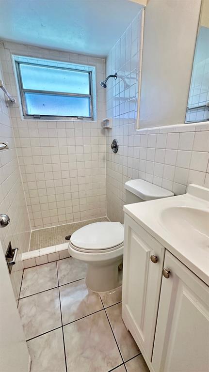 1973 Northeast 4th Street, Unit 2 Deerfield Beach, FL 33441 - Photo 5 of 7 a bathroom with a sink a toilet and shower