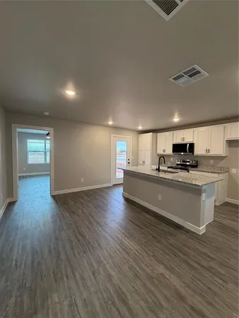 a view of kitchen with sink and wooden floor