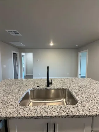 a kitchen with granite countertop a sink and a granite counter tops