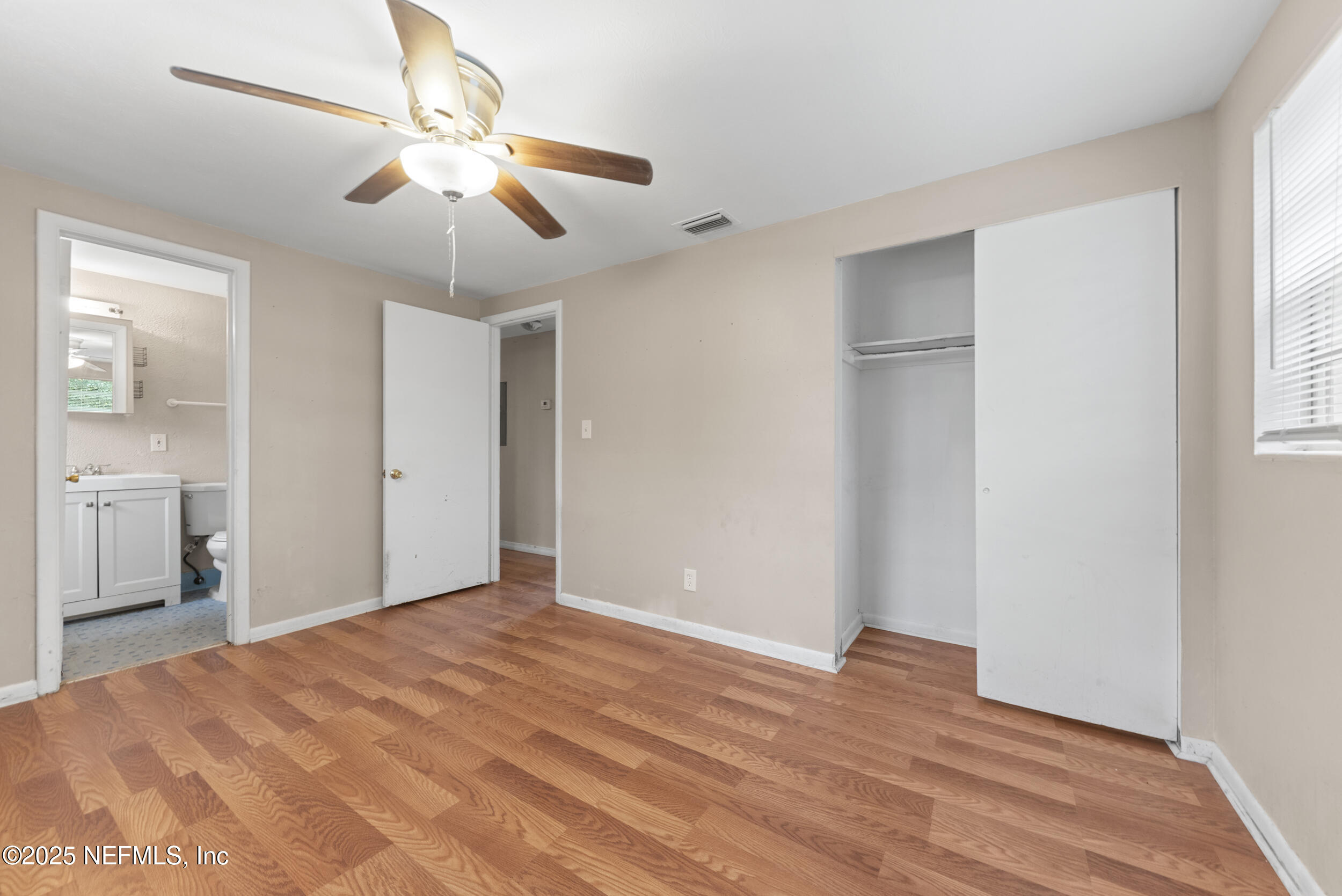 5646 Ricker Road Jacksonville, FL 32244 - Photo 14 of 27 a view of an empty room with wooden floor