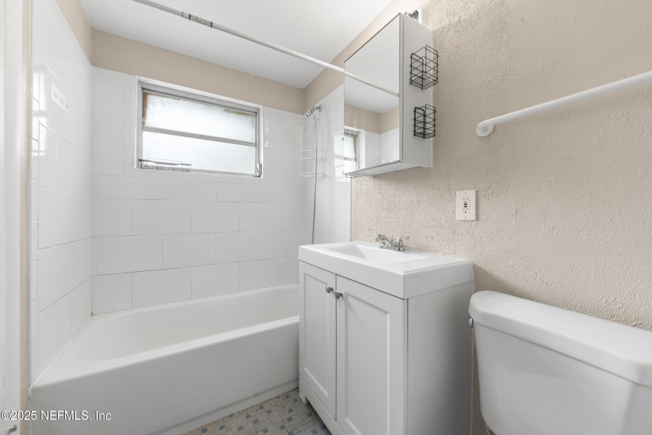 5646 Ricker Road Jacksonville, FL 32244 - Photo 15 of 27 a bathroom with a sink a toilet and bathtub