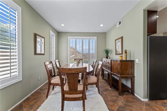a view of a dining room with furniture and window