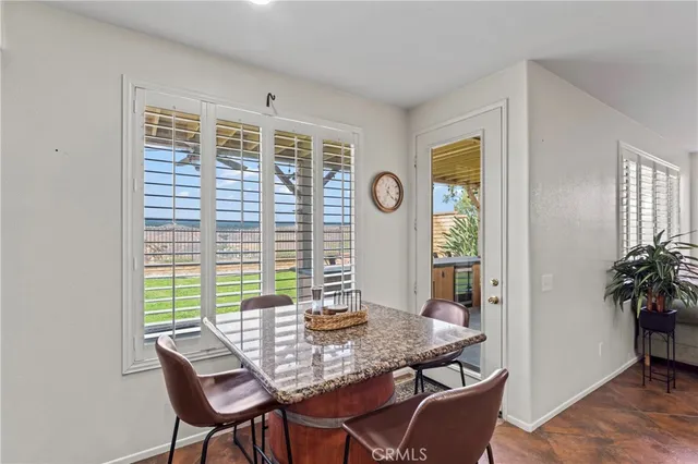 a view of a dining room with furniture and window