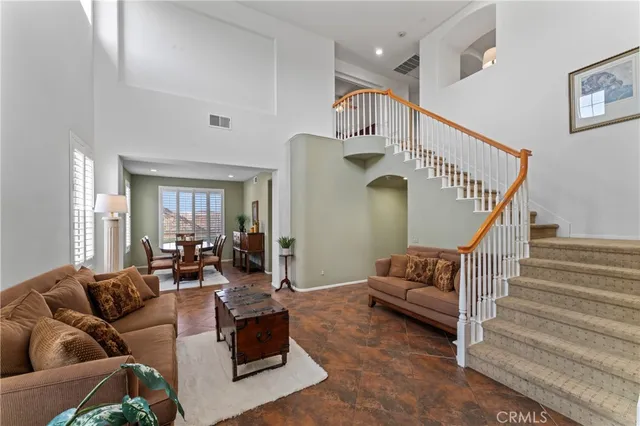 a living room with furniture and stairs