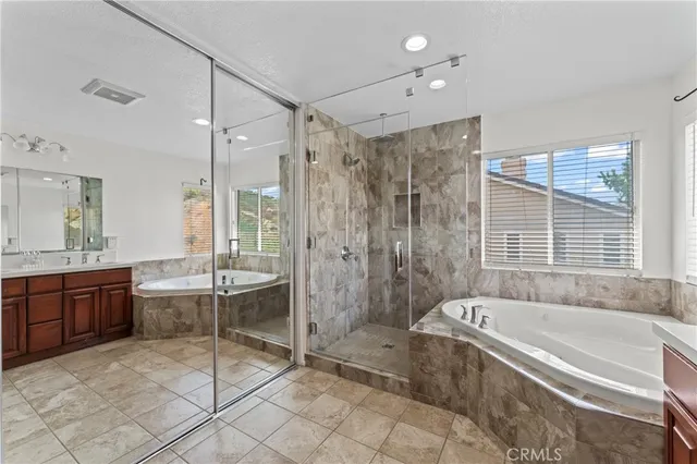 a spacious bathroom with a granite countertop tub shower sink and mirror